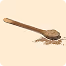 Wooden spoon resting on a light surface with scattered black peppercorns.